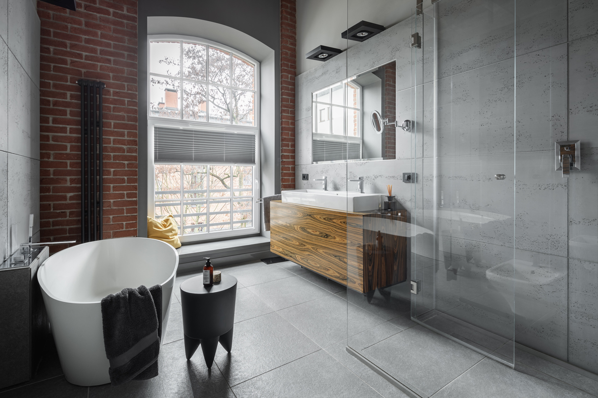 An exposed brick wall in this minimalist bathroom