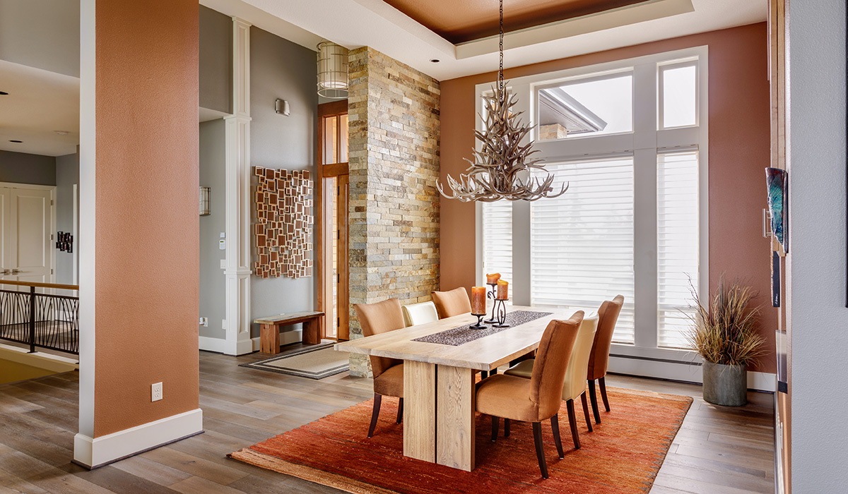 An interior showing a dining room with warm colors